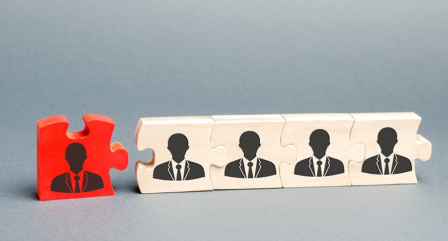 Wooden puzzles with the image of workers. The concept of personnel management in the company. Dismissing an employees from a team. Demotion. Bad worker. Staff cuts. Human resources. Demote